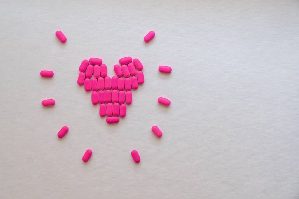 a heart made out of pink tablets